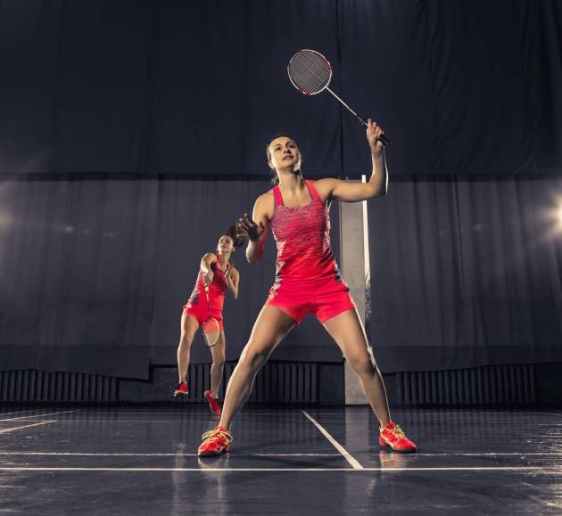 two-young-women-playing-badminton-gym-space-concept-game-pair
